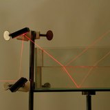 Refraction and reflection of laser light at the boundaries of air and water and water and glass